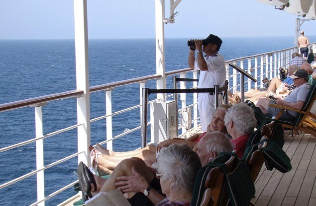 A lookout aboard the Queen Mary 2 scans the horizon for pirates in the Southern Red Sea