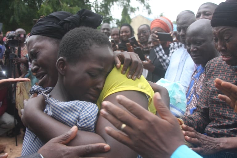 A mother hugs her daughter on July 25, 2021, after she was released together with 27 other students of the Bethel Baptist High School in Kadune state, Nigeria