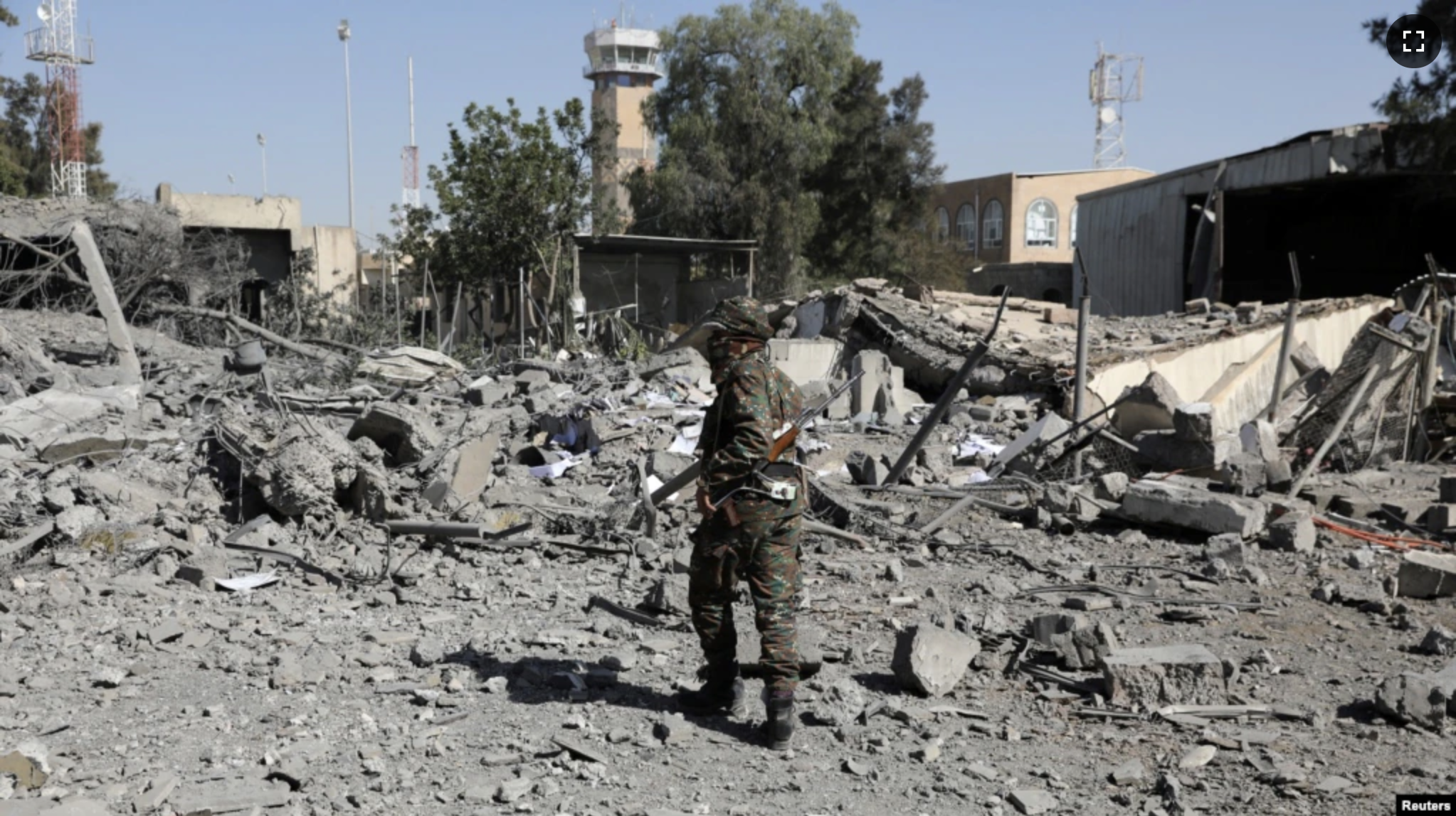 A police trooper walks on the rubble of a building destroyed by Saudi-led air strikes at Sanaa Airport in Sanaa, Yemen, Dec. 21, 2021.