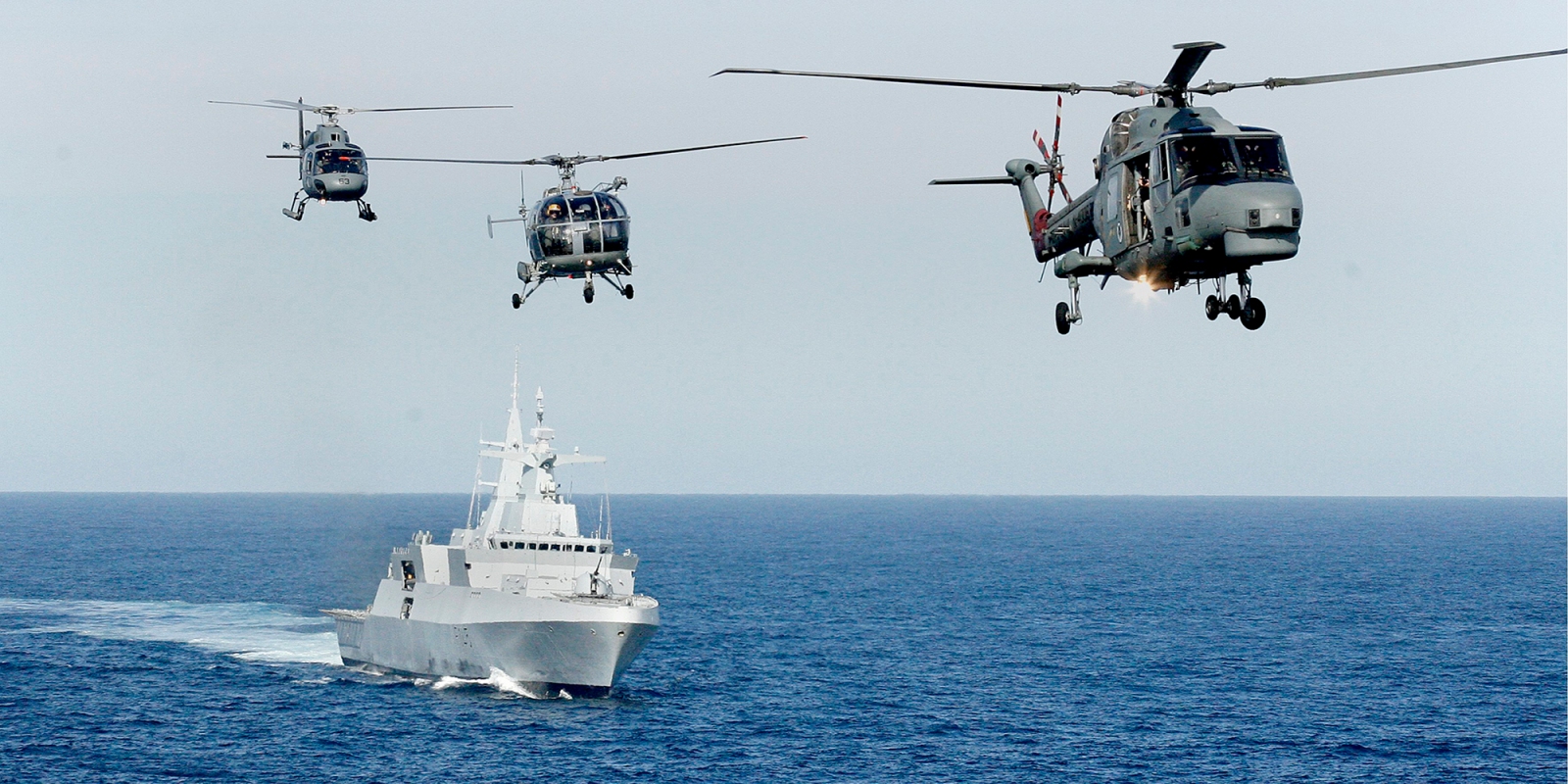 Brazilian and Argentinean helicopters fly in formation over the South African Navy frigate the SAS Amatola in a joint navy operation off the Simon’s Town coastline