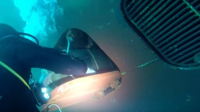 Divers retrieving cocaine hidden in the hull of the ship