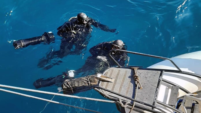 Divers returning to the surface with the watertight bag containing the cocaine