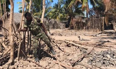 Mozambique soldier clears wreckage after a 2018 attack in Naunde