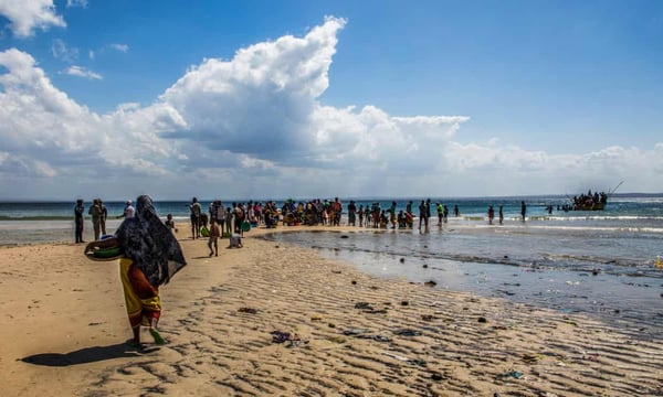 Passengers board a boat from a beach that has become one of the main arrival points for displaced persons fleeing from violence in Cabo Delgado, Mozambique