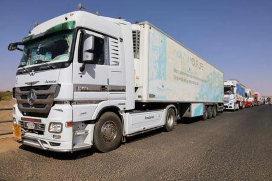 Egyptian trucks wait as the road between Sudan and Egypt is blocked by Resistance Committees, in Northern State, Sudan
